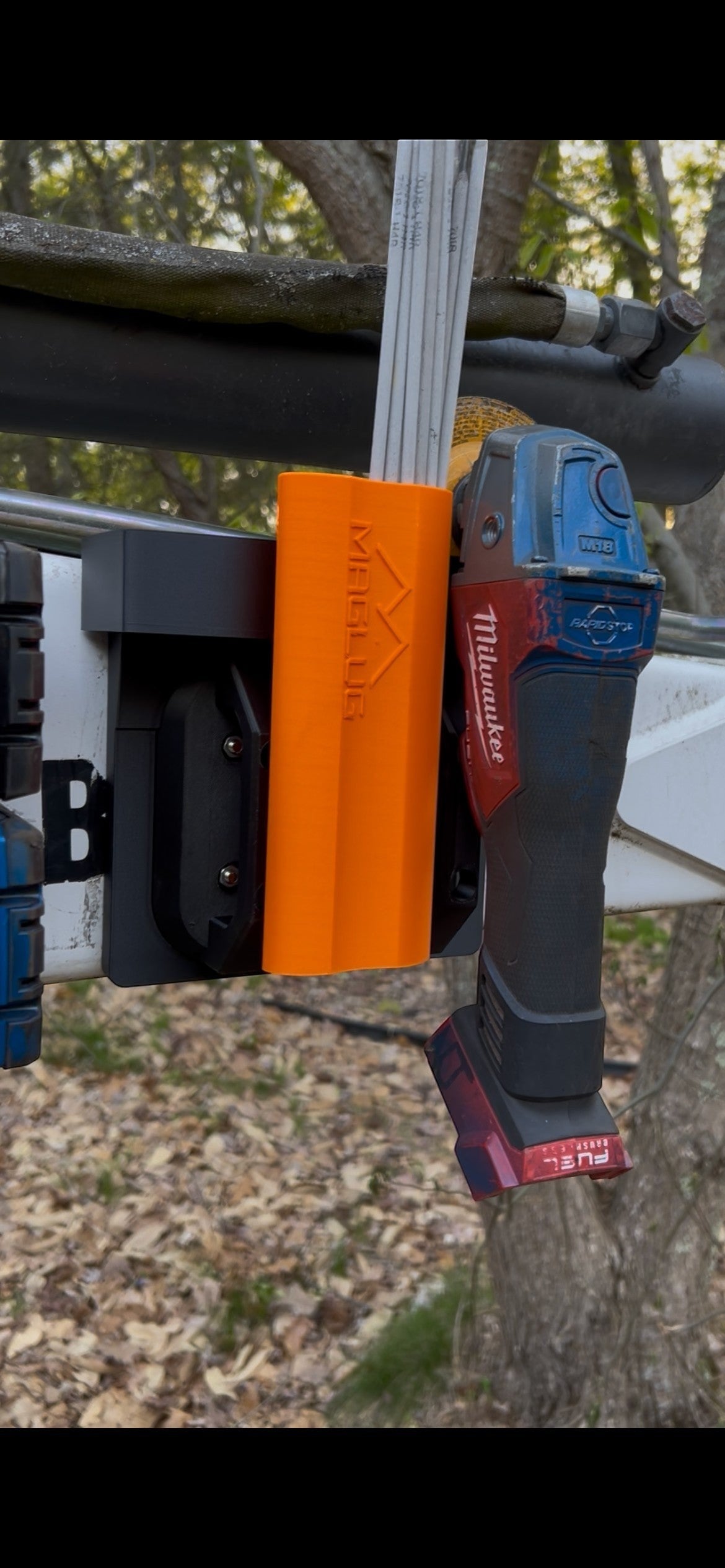 Cold Composites MagLug Magnetic Workstation in orange, holding tools and hardware. Made of carbon fiber reinforced composite.