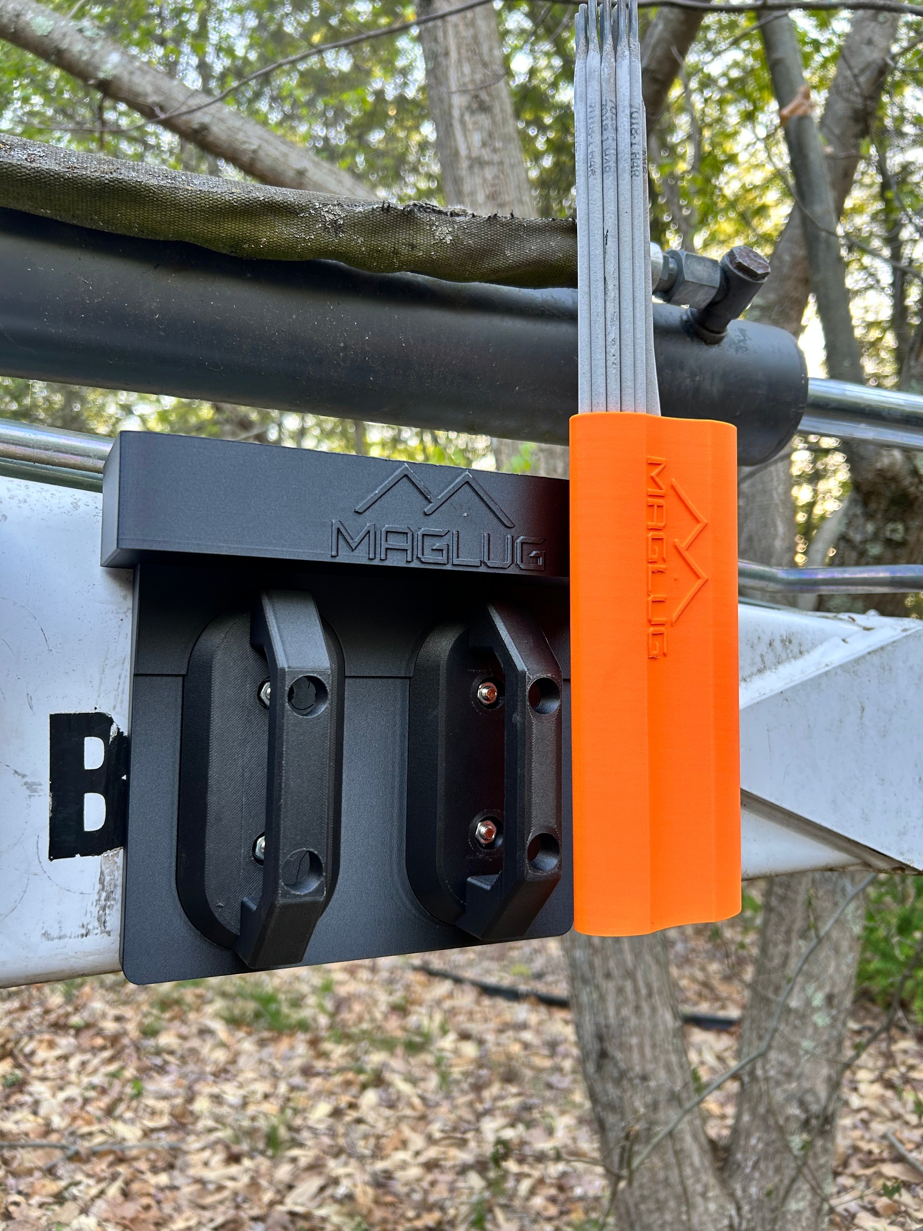 Cold Composites MagLug orange welding rod pouch with belt clip and black base attached to equipment.